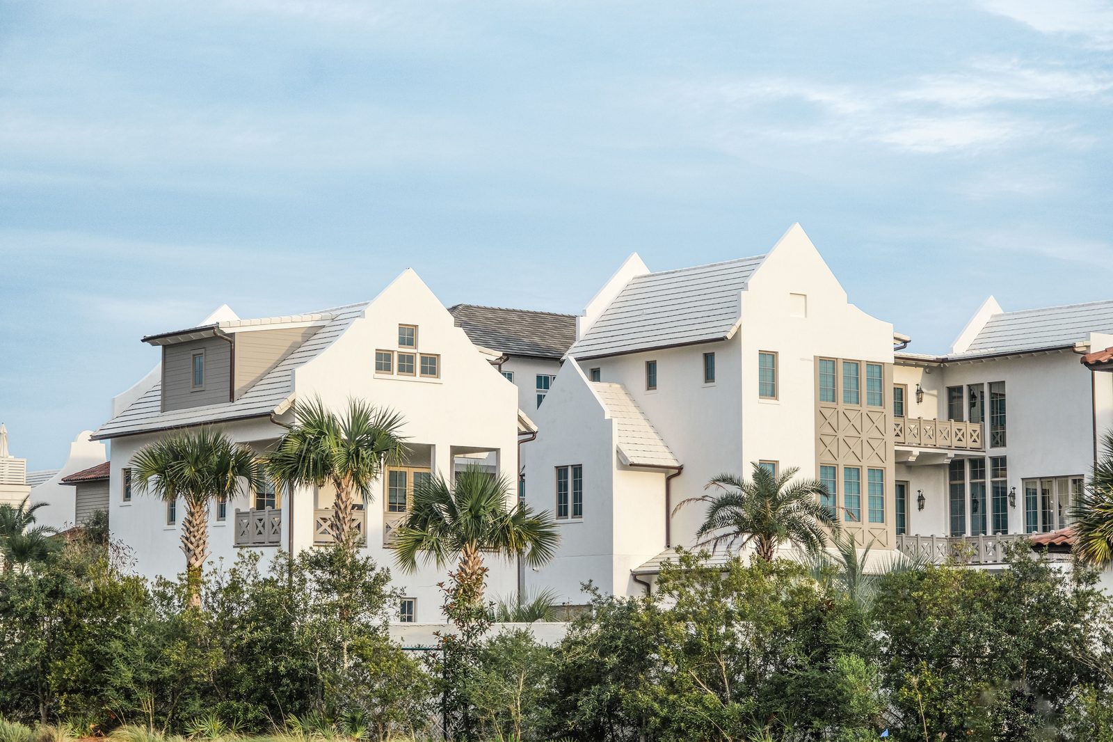 Bright coastal-style homes with clean tile roofs under a blue sky in Hampton Roads